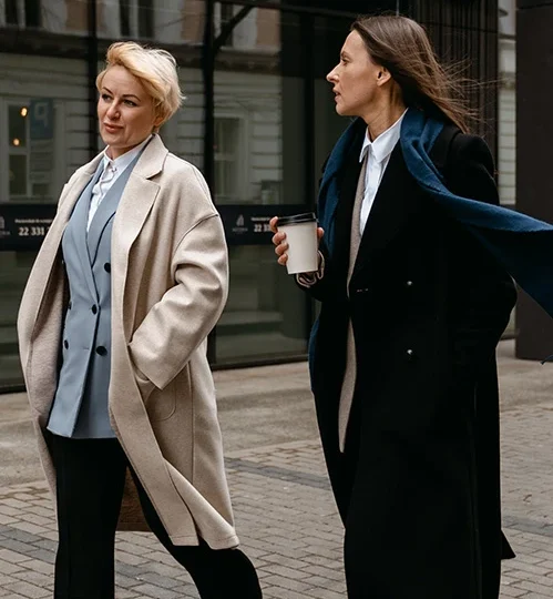h10-4 business women walking with coffee
